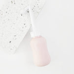peri bottle for postpartum recovery laying on a terrazzo tile