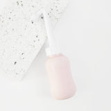 peri bottle for postpartum recovery laying on a terrazzo tile