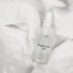 magnesium oil, essential pregnancy self-care on linen